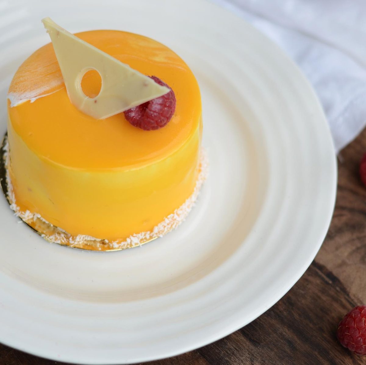 Exotic Délice — a mirror-glazed mango and passion fruit mousse cake