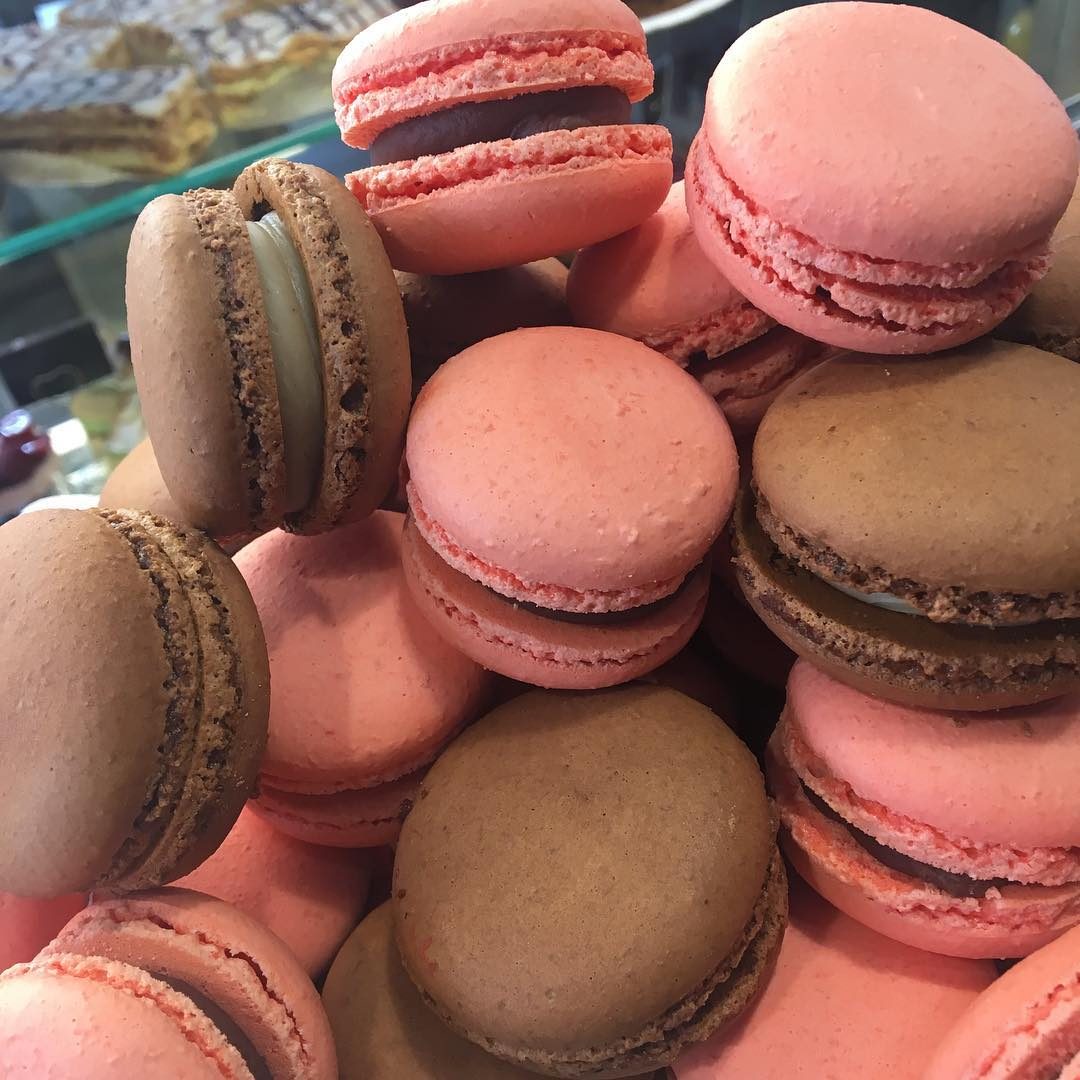 Rose and chocolate macarons stacked together
